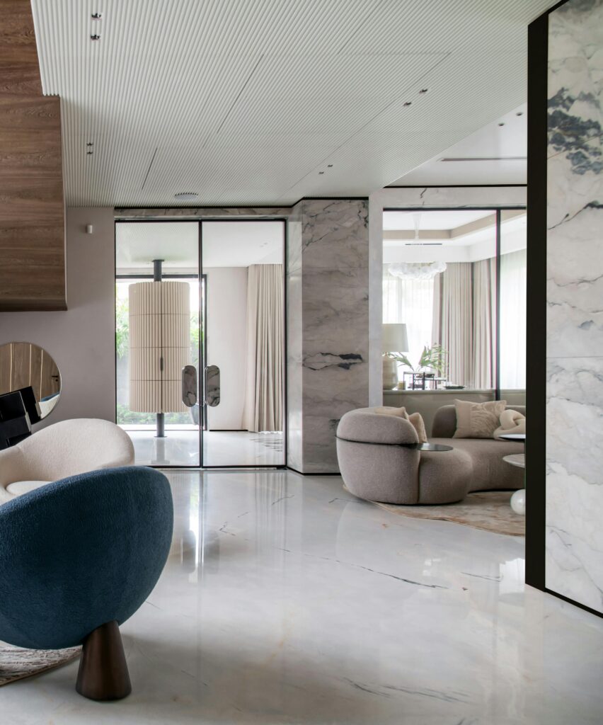 Stylish modern living room with marble floors and contemporary furniture.